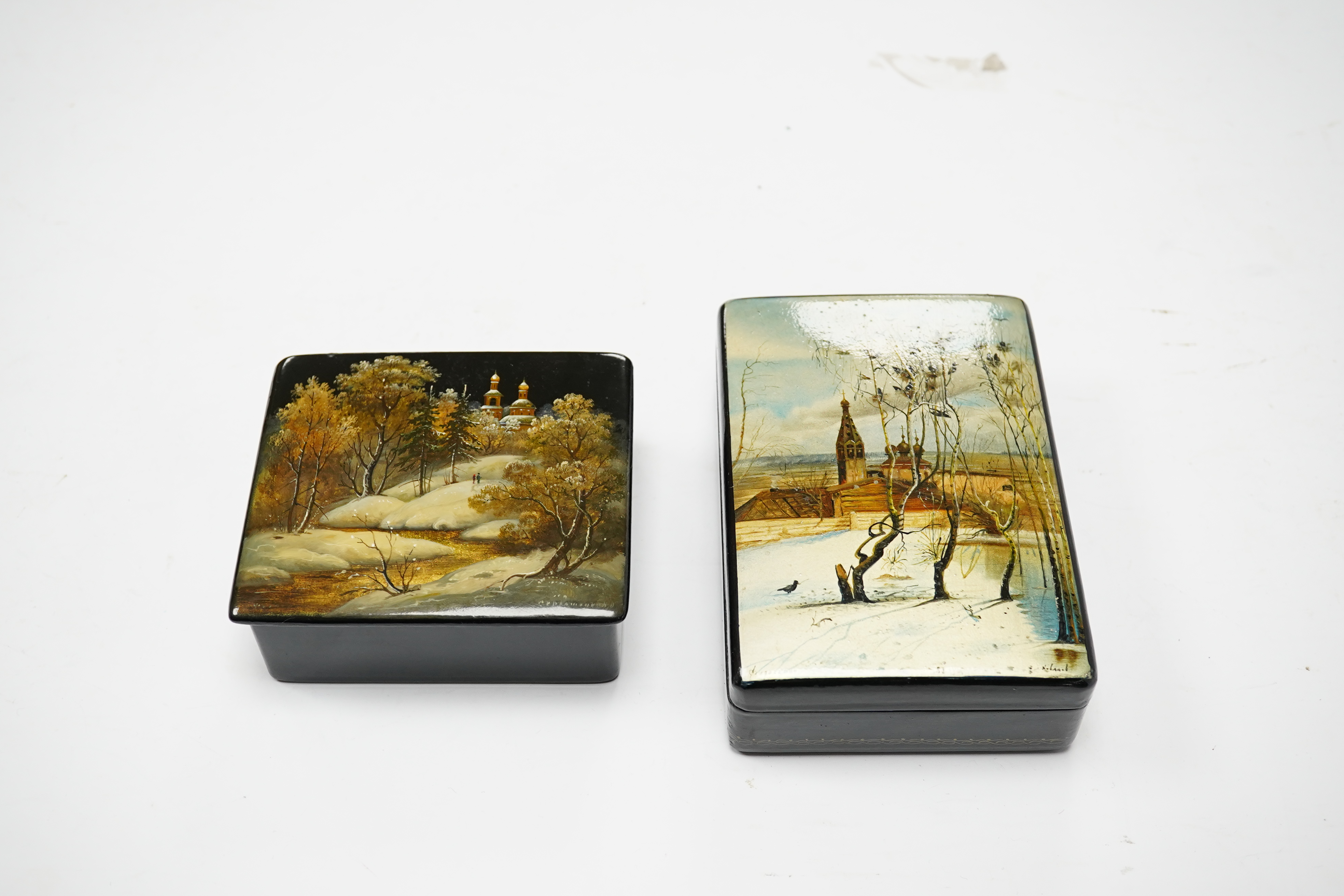 Three late 19th/early 20th century Russian lacquer boxes, decorated with snow scenes, largest 13.5cm. Condition - good